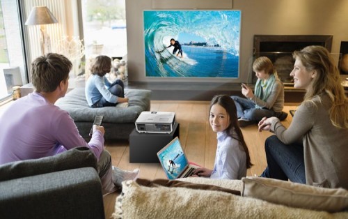 Family using electronic gadgets in a living room